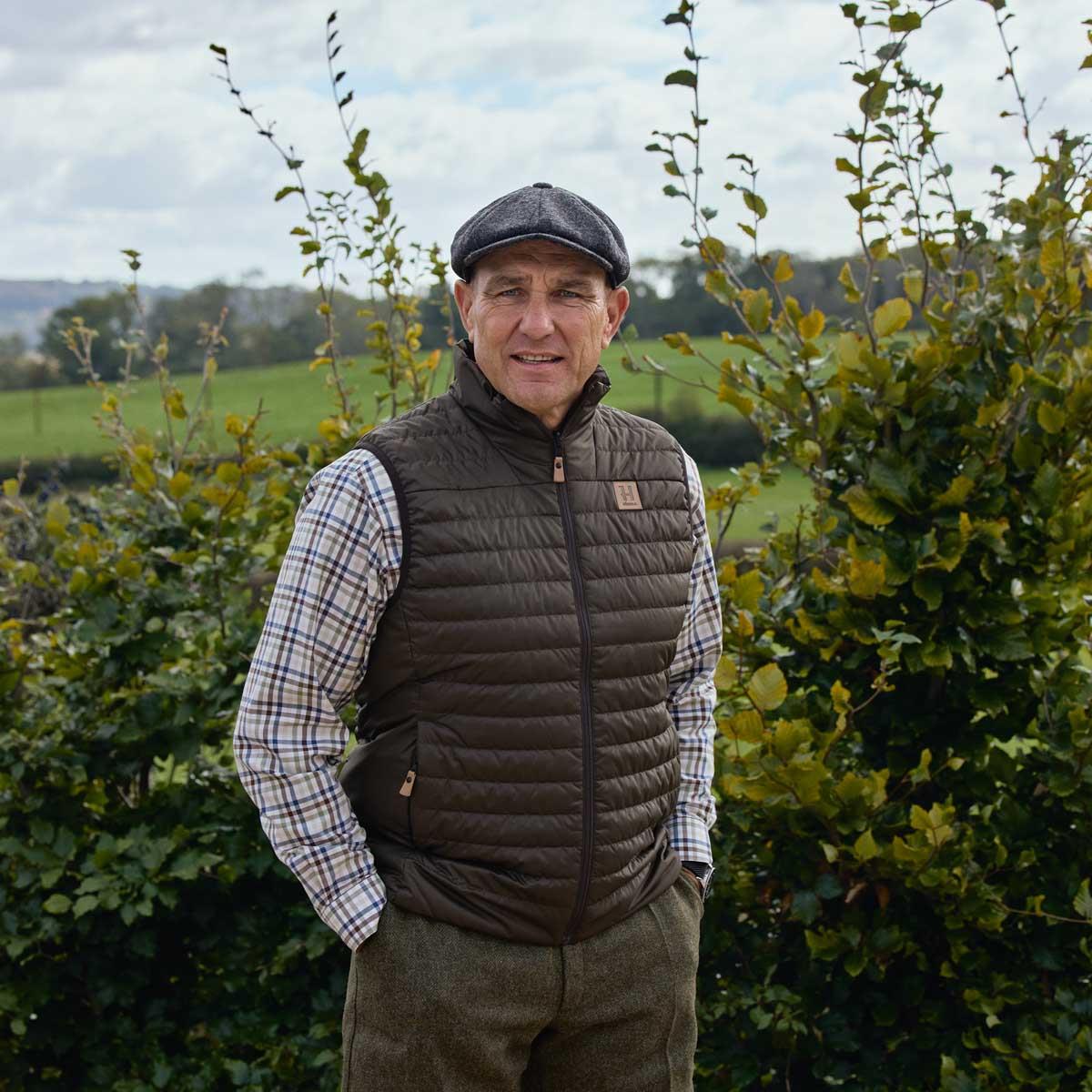 Willow Green/Shadow Brown Harkila Mens Kalix HSP Reversible Waistcoat Reverse Side On Vinnie Jones