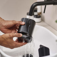 Black Joseph Joseph EasyStore Toothbrush Holder Being Cleaned