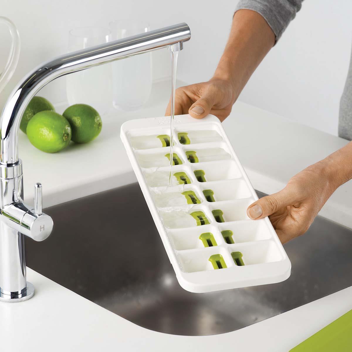 White/Green Joseph Joseph Quicksnap Plus Ice Cube Tray Being Filled